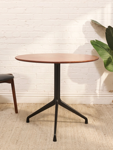 Round Walnut-Tone Pedestal Dining Table with Black Metal Base