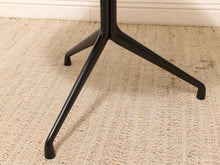 Round Walnut-Tone Pedestal Dining Table with Black Metal Base