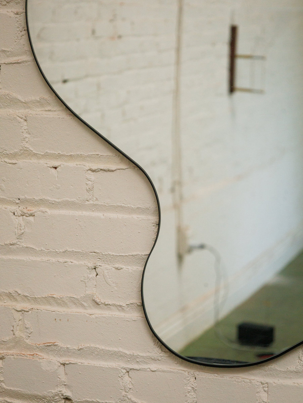 Huge Amoebic black shape mirror sleek black frame